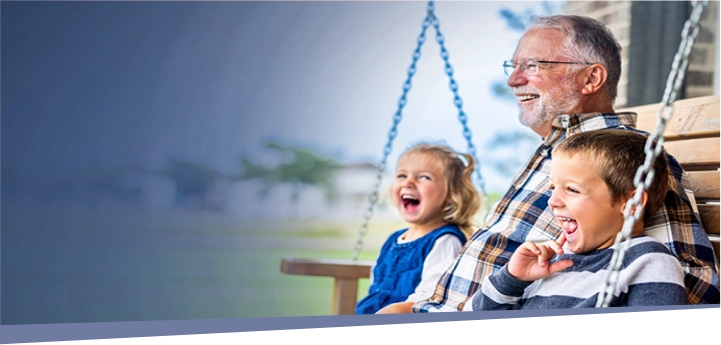 older man enjoying time outdoors with grandchildren
