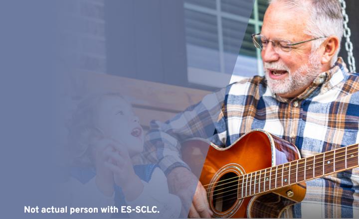 older man playing guitar for grandchildren, representing connection and support during IMDELLTRA® treatment