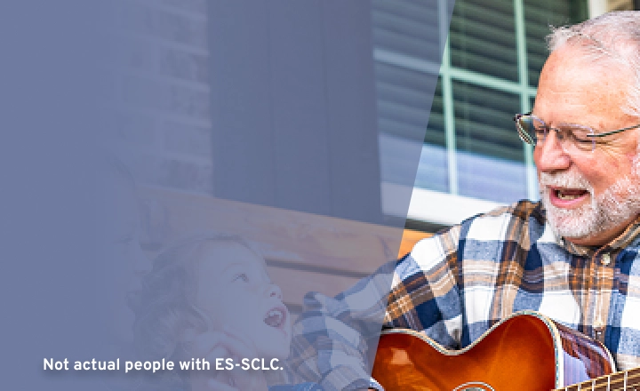 older man playing guitar for grandchildren, representing connection and support during IMDELLTRA® treatment