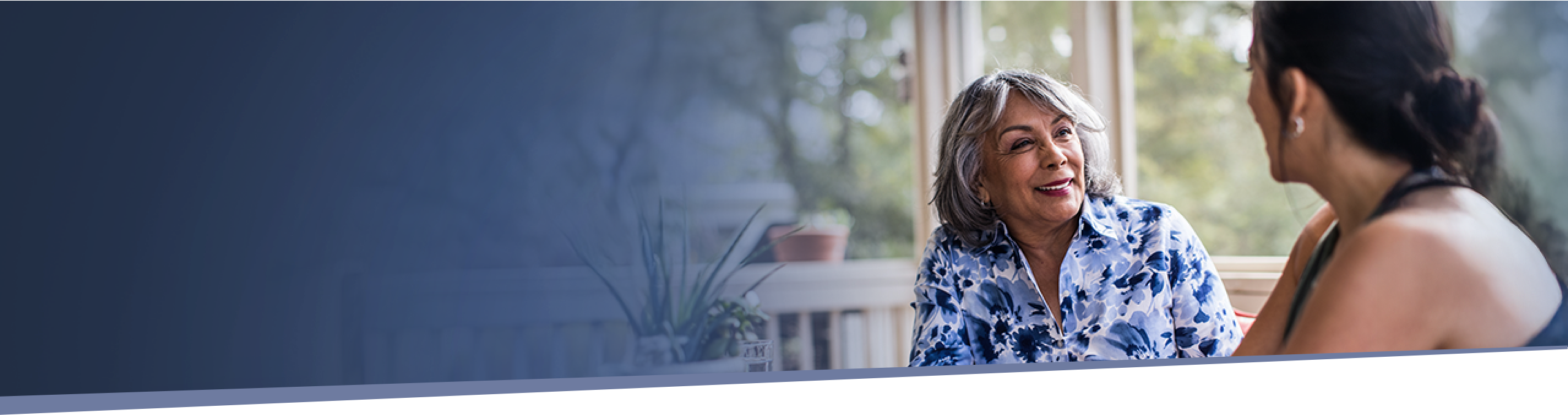 older woman talking with a loved one during IMDELLTRA® treatment discussion