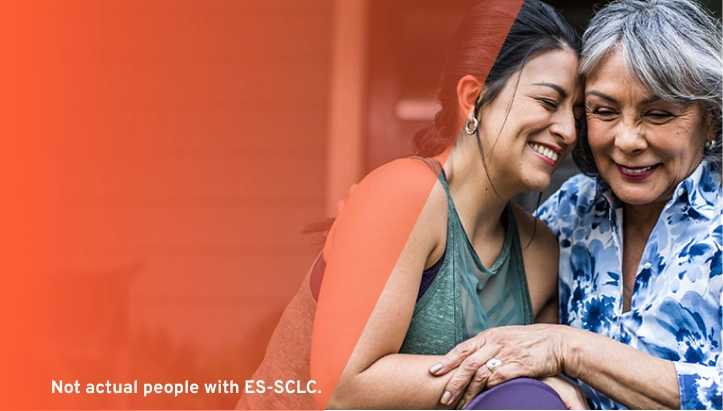 older woman and younger woman smiling and embracing, representing support during IMDELLTRA® treatment