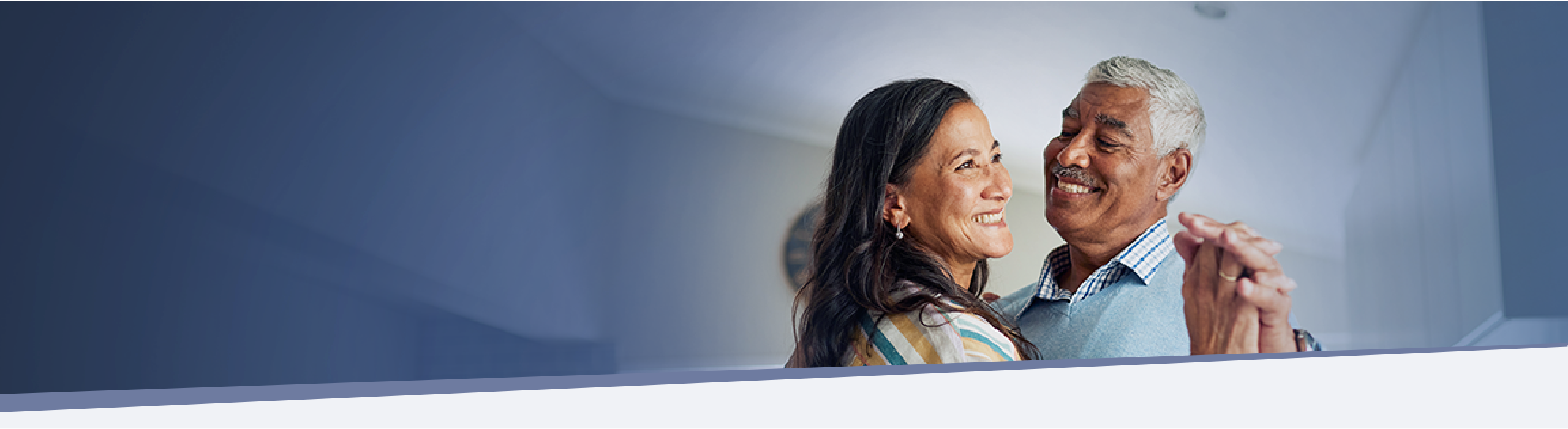 older couple smiling and dancing together indoors during IMDELLTRA® treatment  
